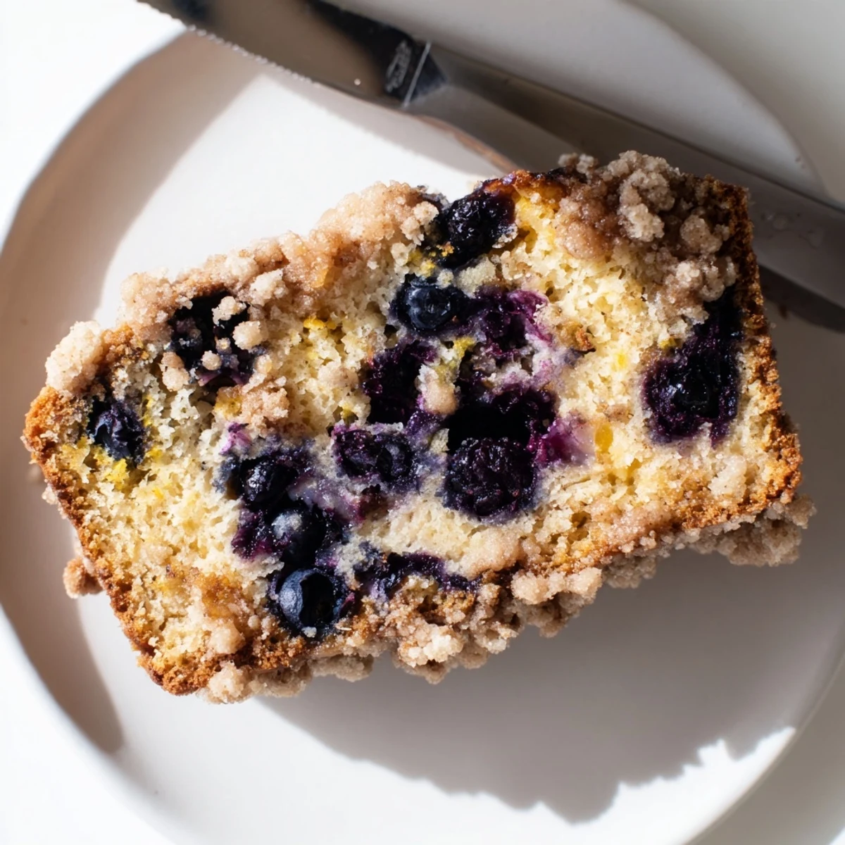 Fresh Lemon Blueberry Bread with Cinnamon Streusel Topping, topped with sparkling sugar, pairs perfectly with a hot cup of coffee.