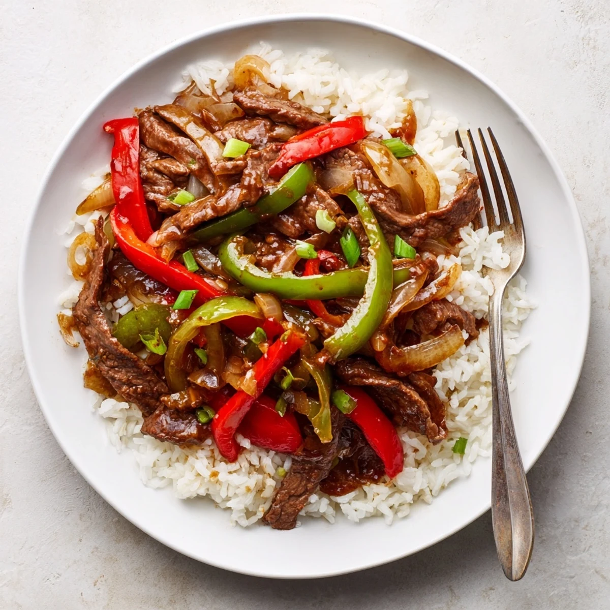 A close-up of sizzling Spicy Beef Stir-Fry with Rice, featuring crisp vegetables and steamed grains ready to be served.