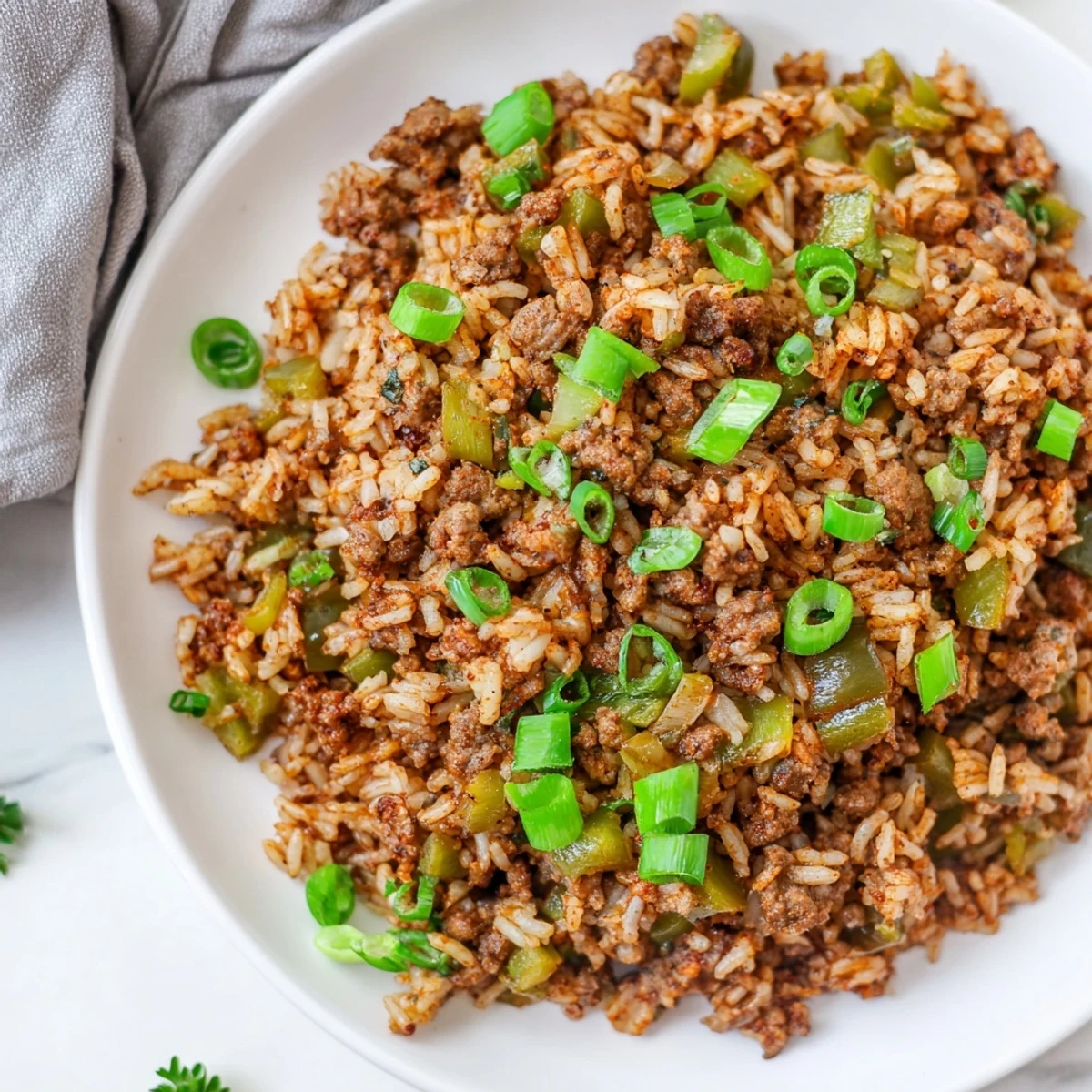 A hearty skillet of Mardi Gras Dirty Rice with Beef and Cajun spices, ready to serve.