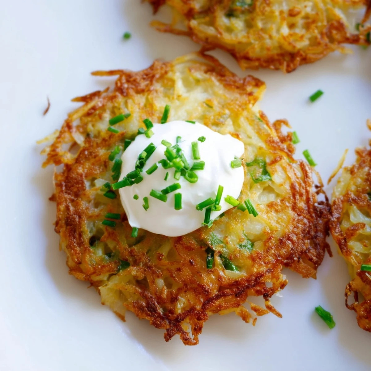 Golden-brown Irish Boxty Potato Pancakes with scallions sizzling in a skillet. 