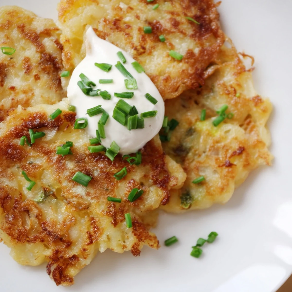 Serving platter of Irish Boxty Potato Pancakes topped with sour cream and chives. 