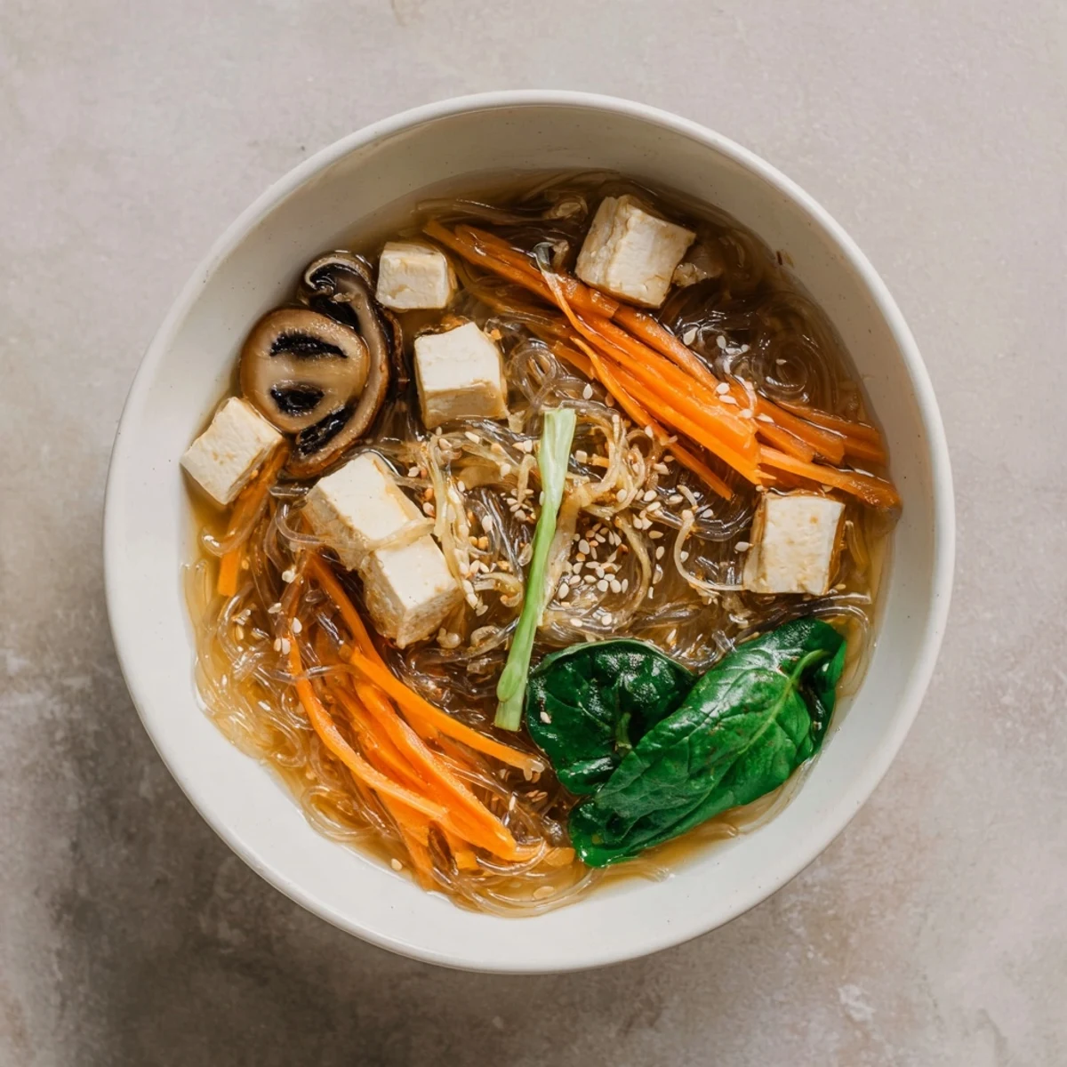 Japanese Harusame Noodle Soup served in a ceramic bowl with julienned carrots.