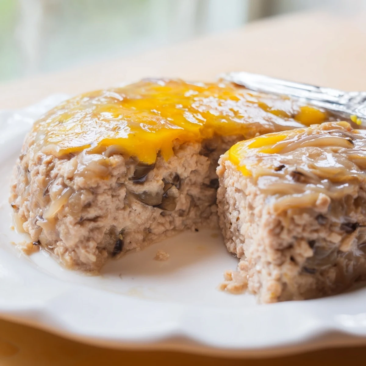Steamed Cha Trung Hap meatloaf with a glossy golden egg topping on a white plate.  