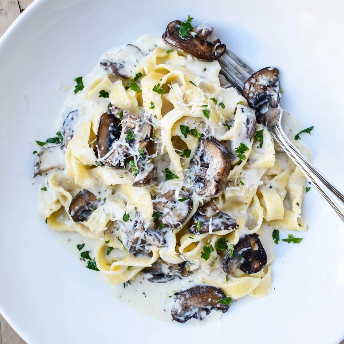A close-up view of Truffle Mushroom Pasta in a skillet, with glossy noodles, wild mushrooms, and shaved truffles, perfect for a cozy Italian dinner at home.