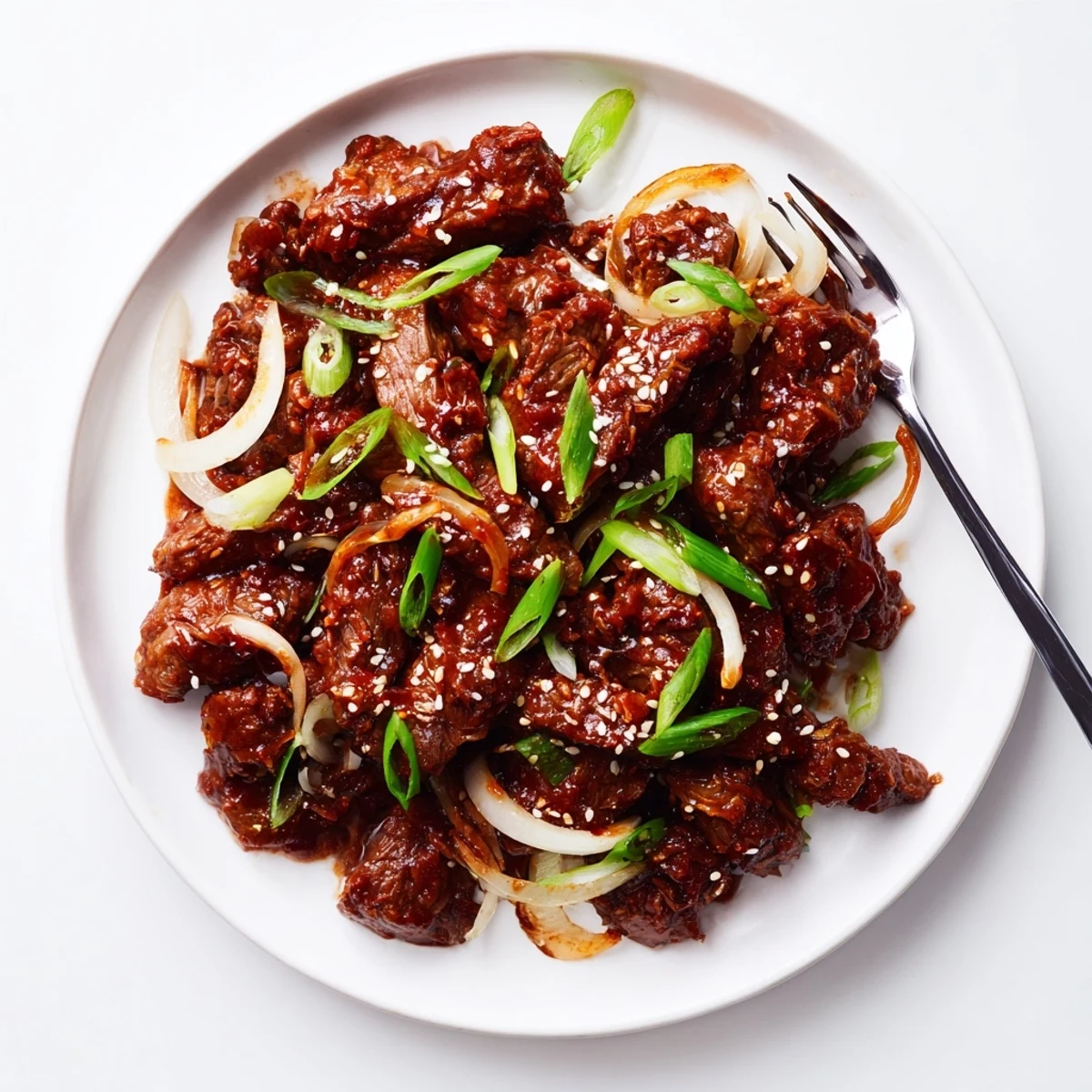 Tender slow cooker Korean beef coated in glossy brown sauce over fluffy white rice
