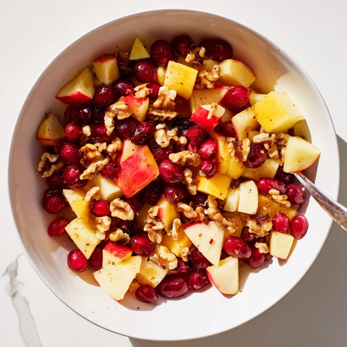 Glistening Minute Fall Fruit Salad in white bowl featuring autumn fruits drizzled with orange-cinnamon honey glaze