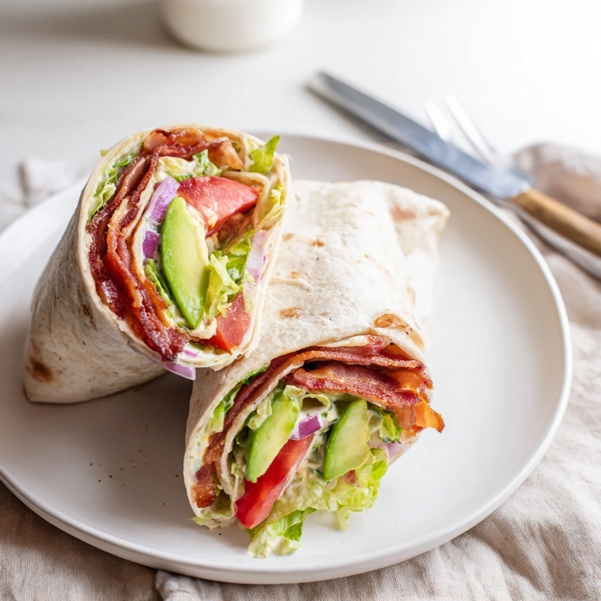 Open Meal Prep BLT Wraps reveal crunchy lettuce, warm tortillas, tangy mustard mayo.