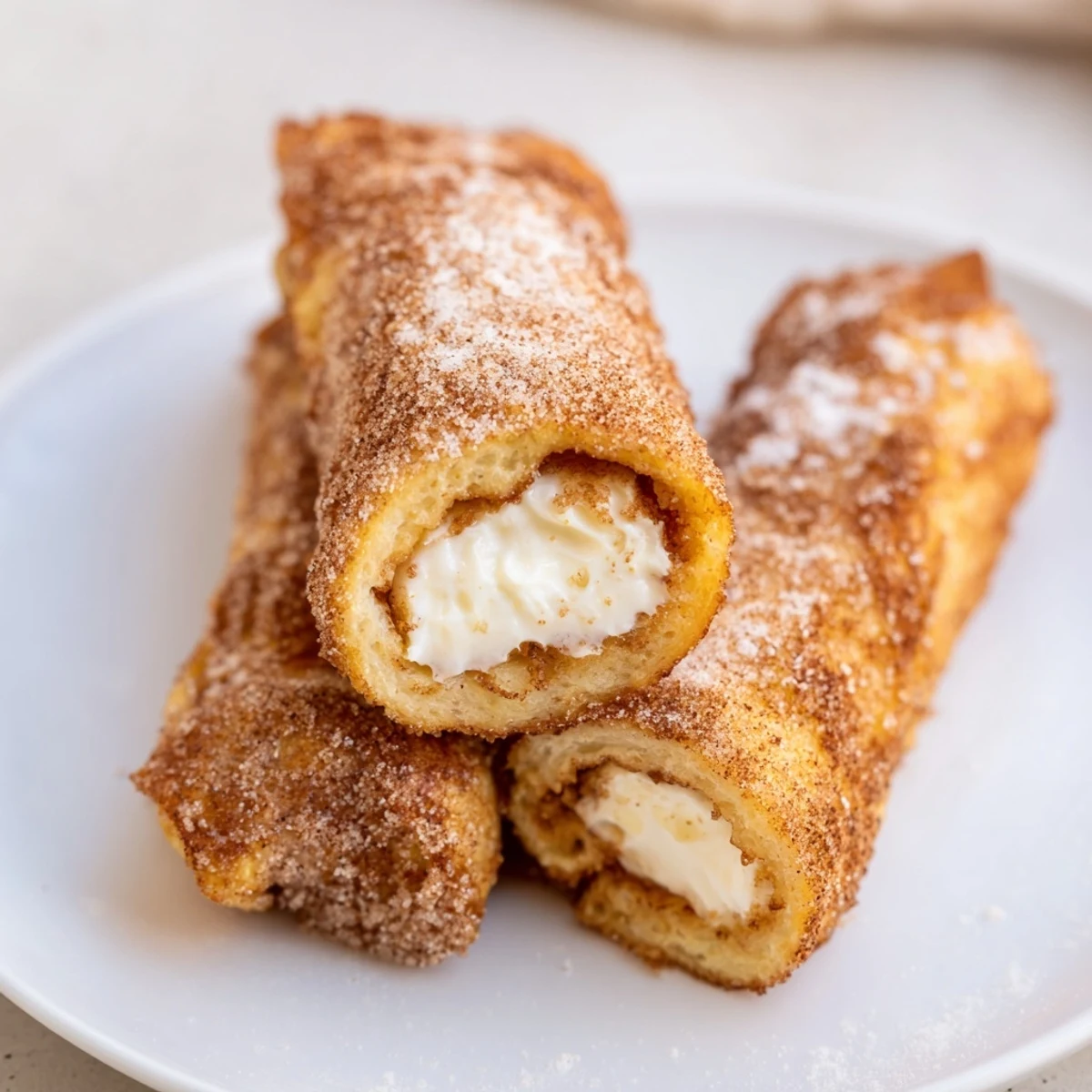 Skillet browned Cinnamon Roll French Toast Roll Ups, dusted with powdered sugar