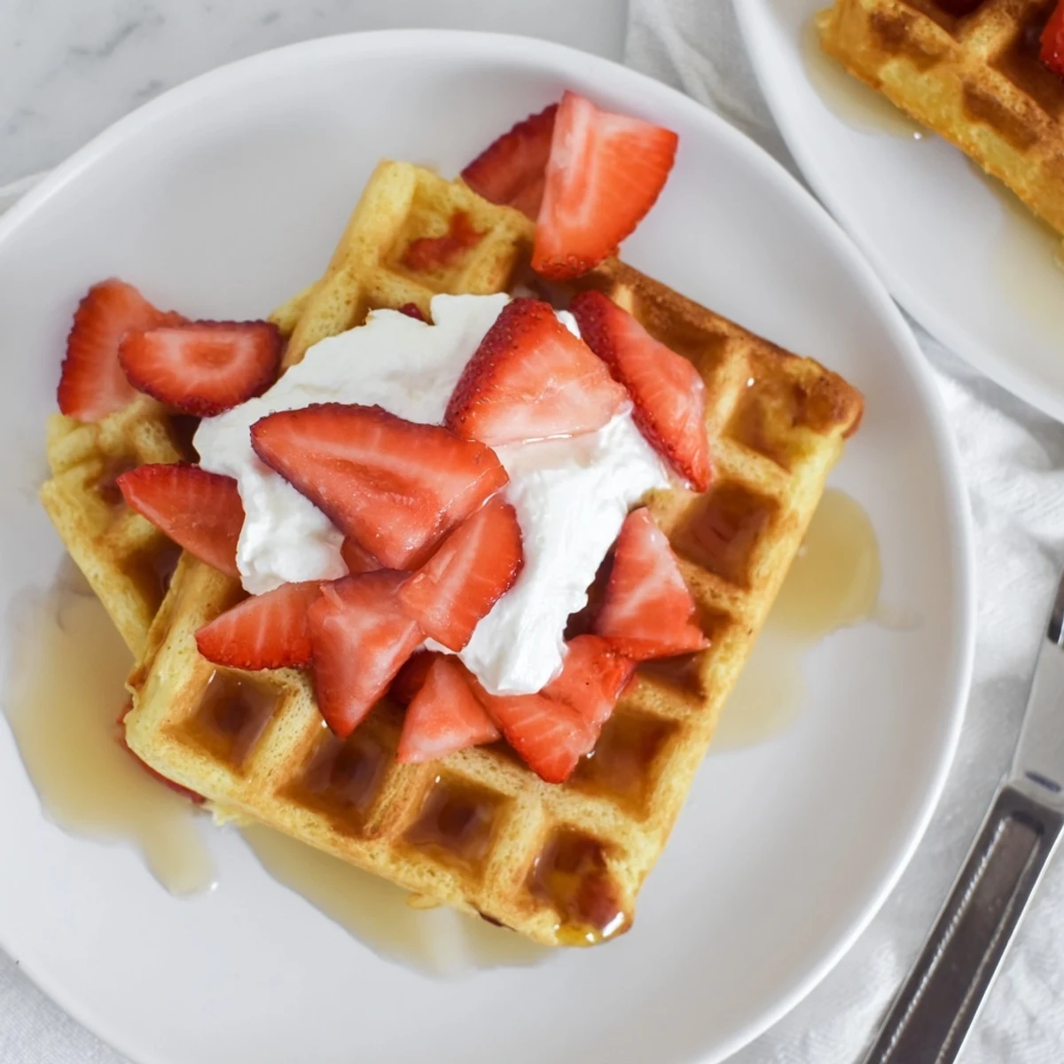 Strawberry Waffles Recipe: golden, fluffy waffles studded with fresh strawberries and syrup