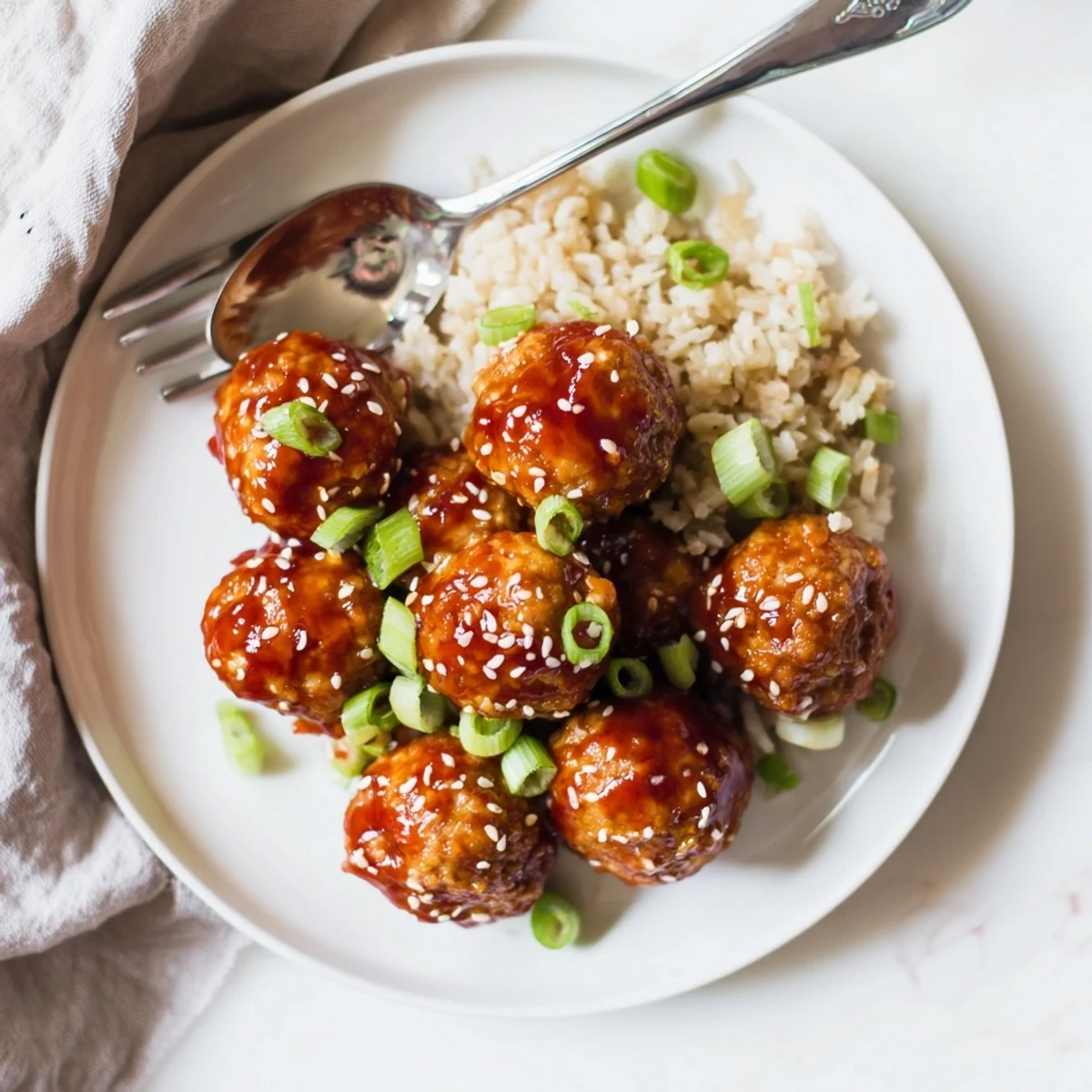 Crispy baked sweet chili tofu balls served on white rice with sesame seed topping