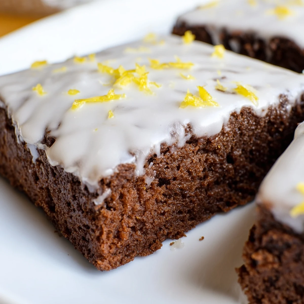 Fudgy lemon butter brownies cut into squares featuring crackled tops and powdered sugar dusting