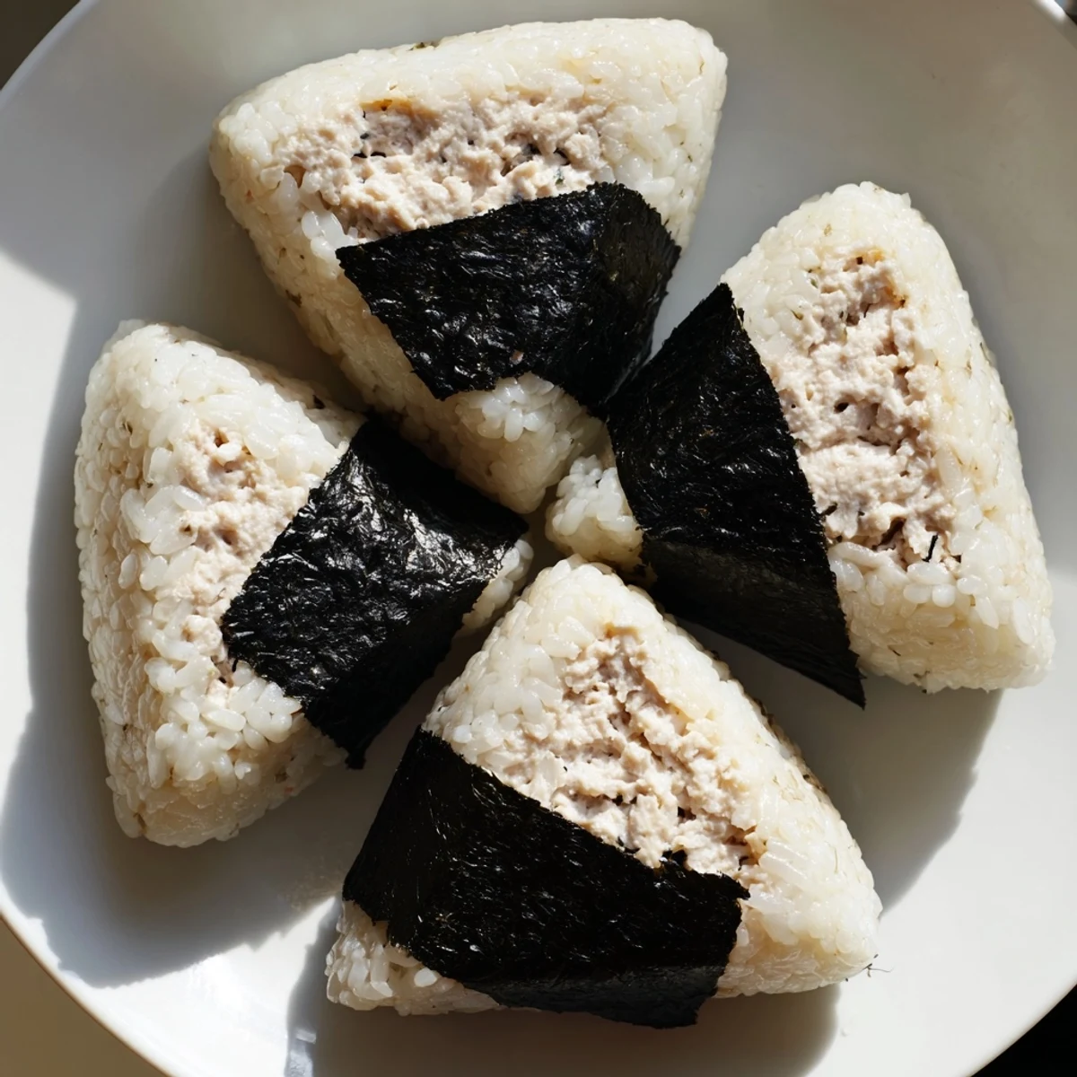 Golden triangle shaped tuna mayo onigiri wrapped with crispy nori seaweed strips