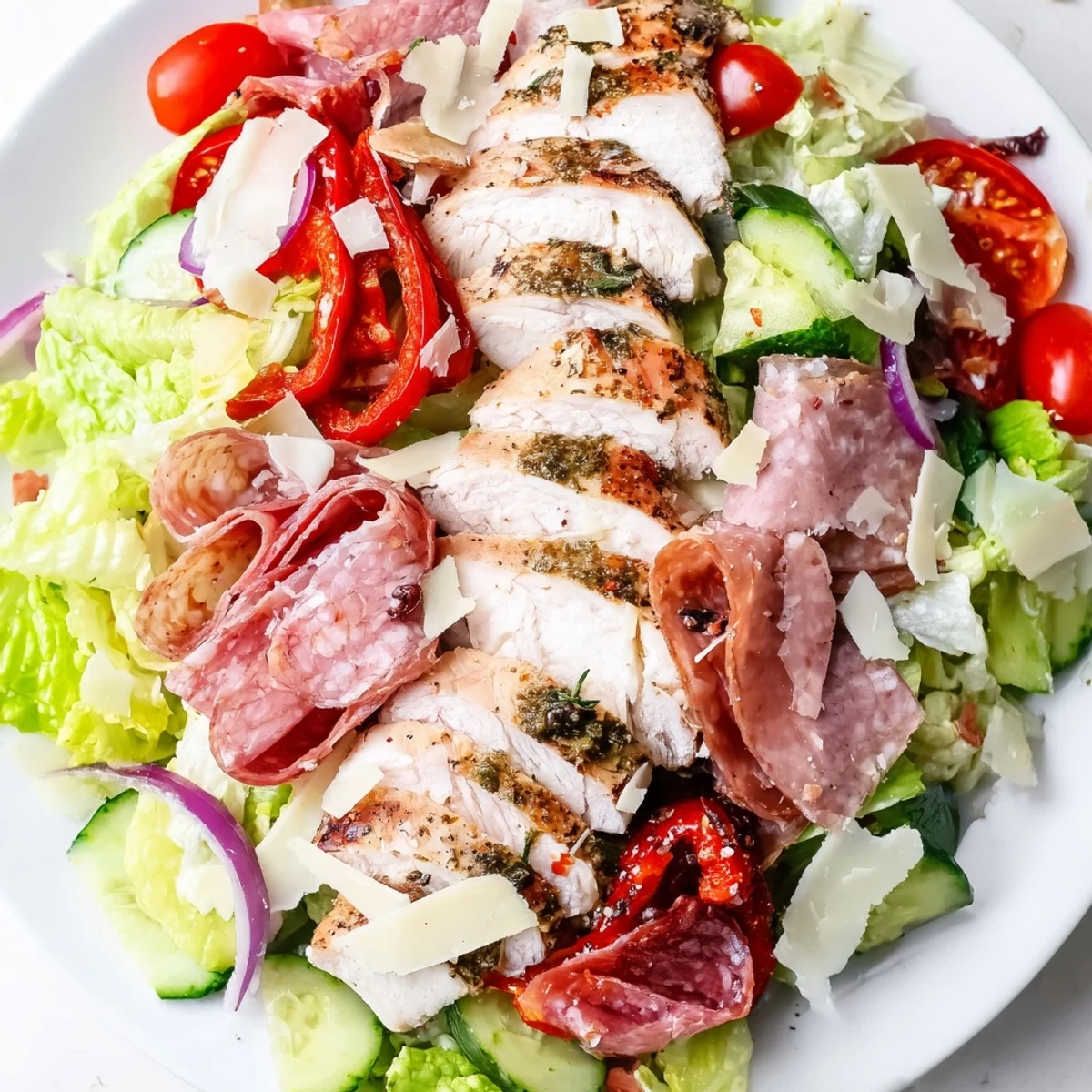 Italian Grinder Chicken Salad topped with salami, provolone, and tangy pepperoncini dressing