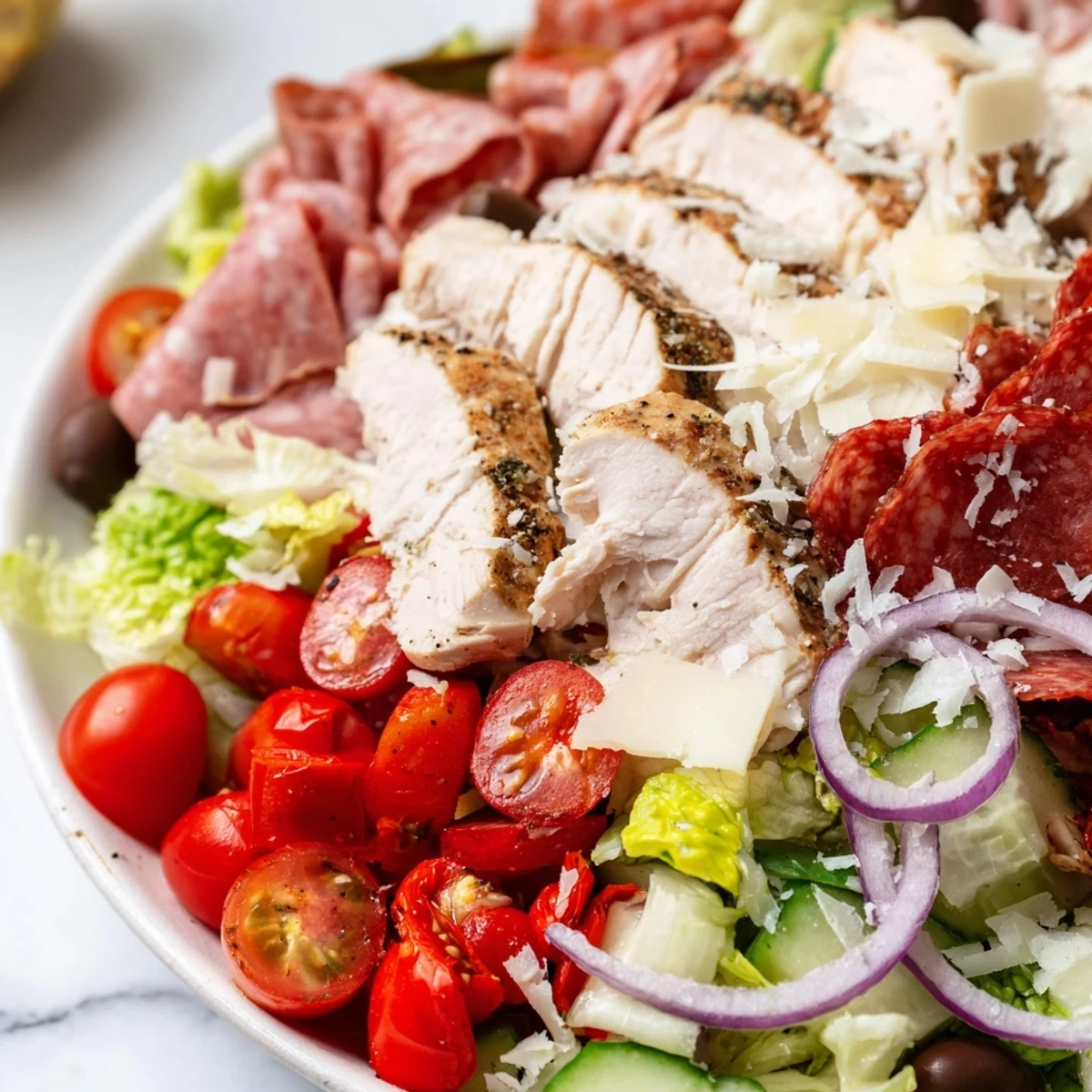 Crisp romaine layered with juicy grilled chicken, ham, and shredded Parmesan in Italian Grinder Chicken Salad