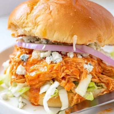 Soft buns encase spicy Buffalo chicken, crisp iceberg lettuce, and tangy blue cheese, creating a mess-free game day bite. 