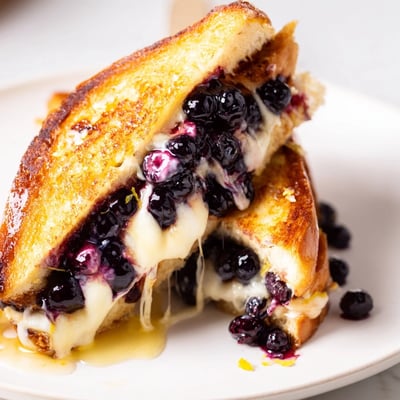 Slice of Juicy Blueberry Grilled Cheese steaming, sweet blueberries bursting inside