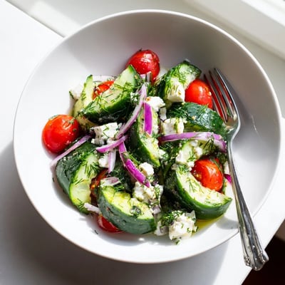 Creamy feta cucumber herb salad drizzled with bright lemon olive oil dressing